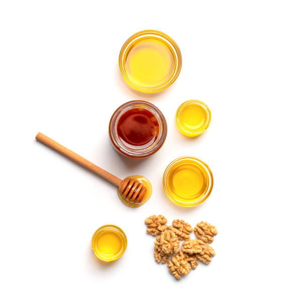 istock Honey and walnuts on a white background top view 2099499296