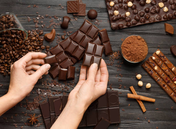 istock Chocolate, candy, hazelnuts, cocoa powder on a dark background 2099501365