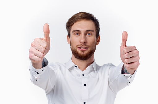happy young man showing thumb hand gesturing emotion model. High quality photo