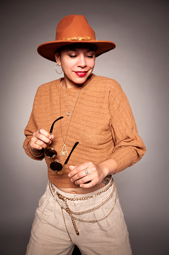 Studio Portraits of Fashionable Woman with Hat and Glasses.