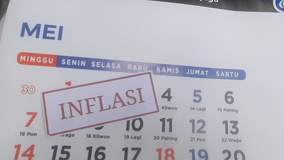 inflation label with May month calendar background