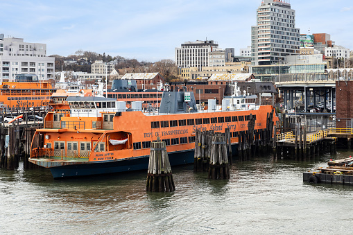 Staten Island, NY, USA - December 11, 2023: A Staten Island Ferry docked in Staten Island after transporting people from Lower Manhattan.