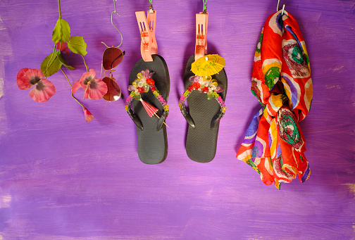 colorful family sandals in white sand on a perfect Caribbean beach