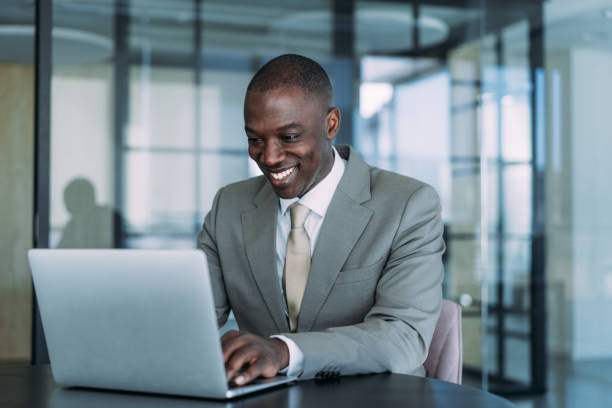 istock Successful businessman in modern office working on laptop. 2099549311