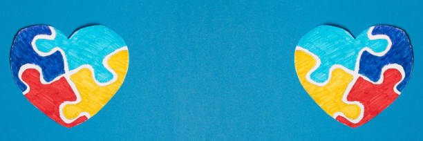 istock Banner. Colorful puzzle heart on a blue background 2099550933