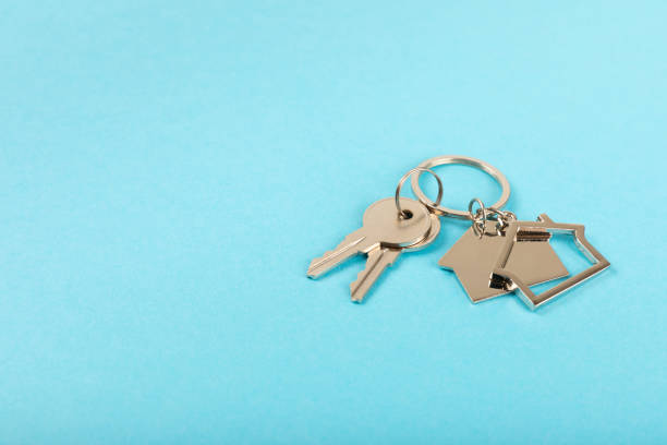istock Plastic key ring in different colors with a place for a signature on a bright colored background. Bunch of keys with keychain. Mock-up keychain.Copy space.Concept for renting and selling real estate. 2099553035