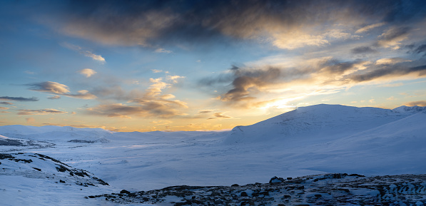 panoramic view of the mountains of Dovrefjell National Park at sunset in winter - Oppdal – Norway