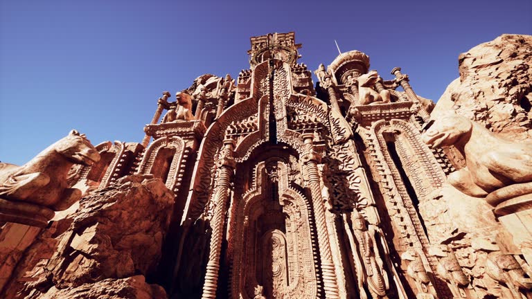 A towering building adorned with intricate statues on its walls