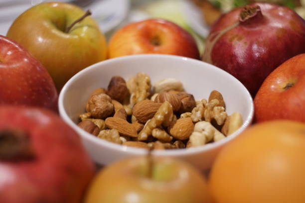 Healthy food background. Different fruits and nuts in a bowl.