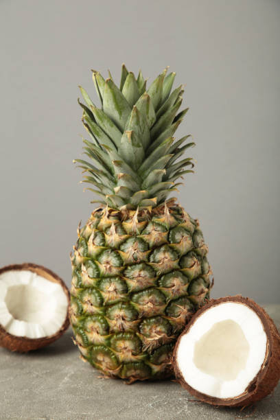 istock Pineapple with coconut on grey background. Tropical fruit 2099651999