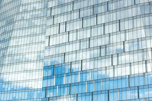 Clouds reflected in the windows of a modern office building.