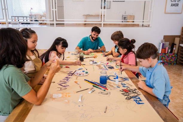 istock Kids painting on cardboard poster during paint class at workshop 2099675092