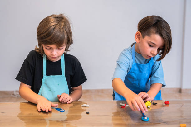 istock Child brothers playing with clay at house 2099675629
