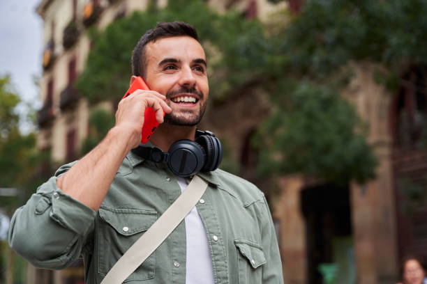 istock Handsome man using telephone to call friends, talking and having a nice conversation by phone. 2099681989