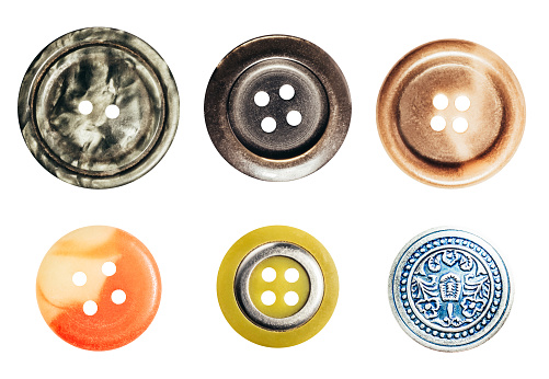 Isolated photo of various clothing and sewing buttons accessories on white background.