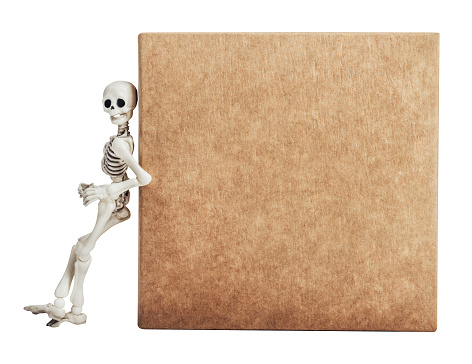 Isolated photo of toy skeleton standing and leaning on carboard box on white background, side view.