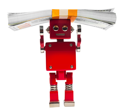 Isolated photo of red toy robot holding money pack on white background.