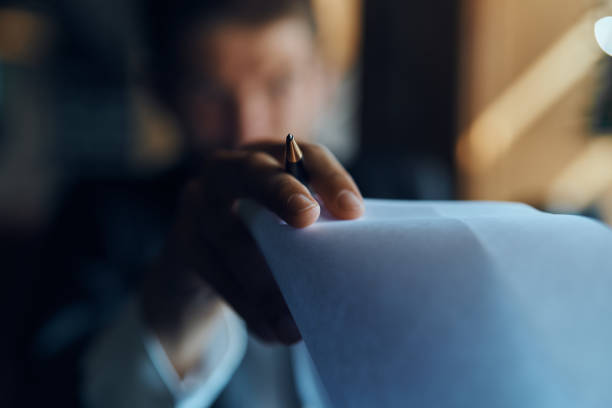 istock business man sitting at a table in a cafe documents work official coffee cup 2099691646