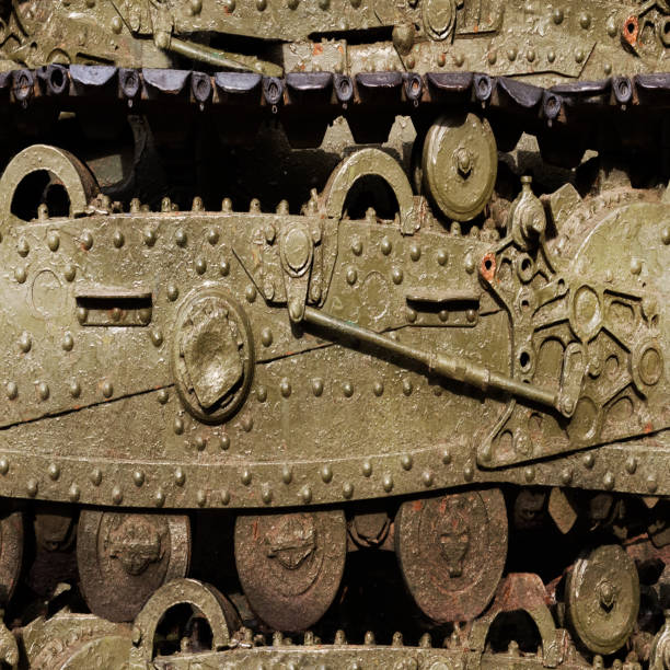 Side view of military tank moving in the war field over burned city
