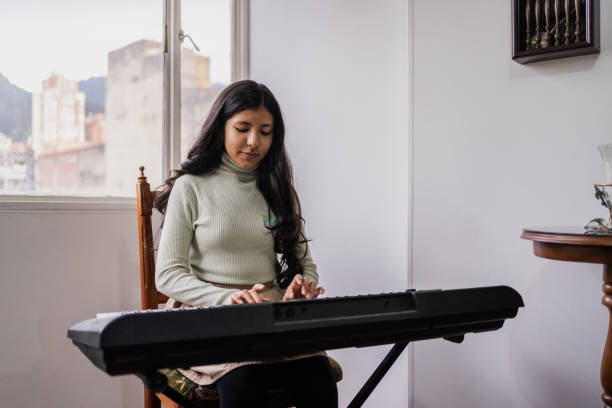 istock Girl playing synthesizer at home 2099702035