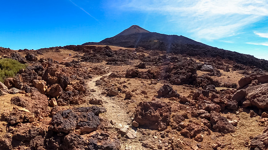 Solidified lava, ash and pumice on volcanic terrain. Black and brown dark sand and rocks on bare terrain. Scenic view on volcano Pico del Teide, National Park, Tenerife, Canary Islands, Spain, Europe