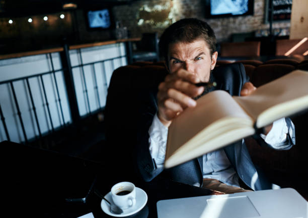 Business man sitting in a cafe in front of a laptop with a cup of coffee work technology lifestyle