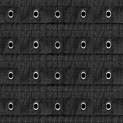Seamless texture photo of black denim striped belt with stitches and rivets.