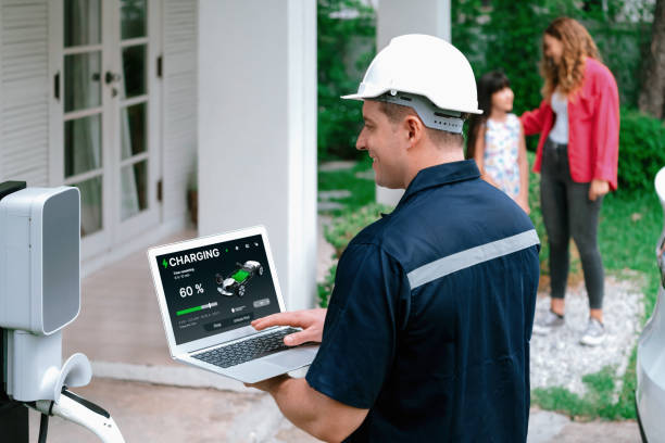 istock Qualified technician working with laptop for home EV station. Synchronos 2099710040