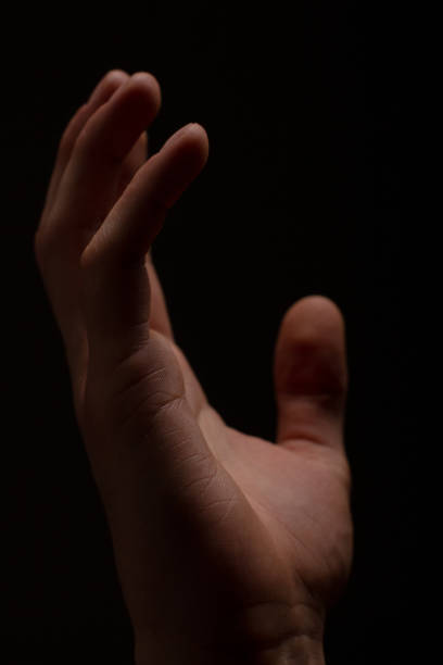 istock right wrist, close-up on a black background 2099714336