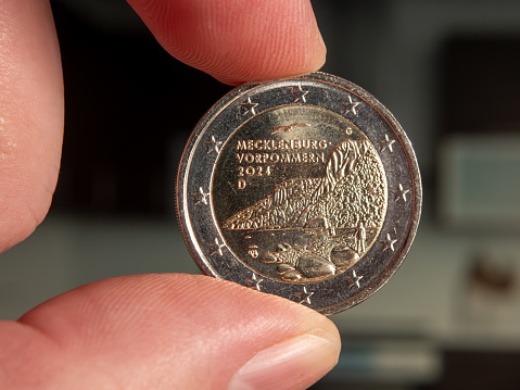 Close-up of Commemorative Two Euro Coin from Mecklenburg-Vorpommern Held Between Fingers
