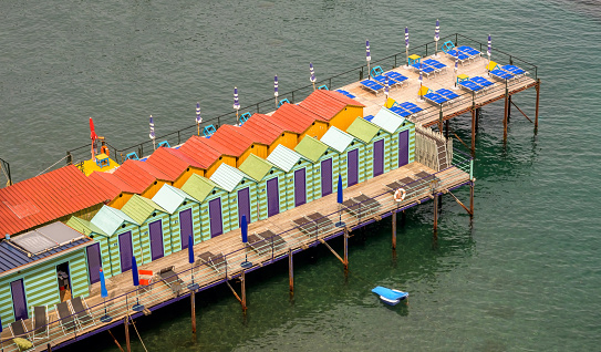 Aerial view of colorful over the water changing rooms on the coast of Sorrento, Italy.