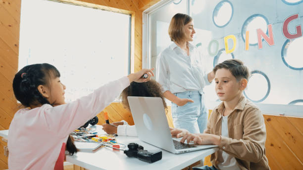istock Smart teacher teaching and looking student using laptop at classroom. Erudition. 2099728913