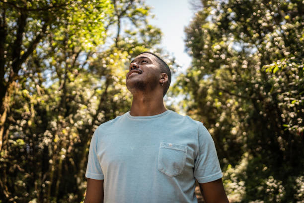 istock Young man walking and looking around hiking on forest 2099740674