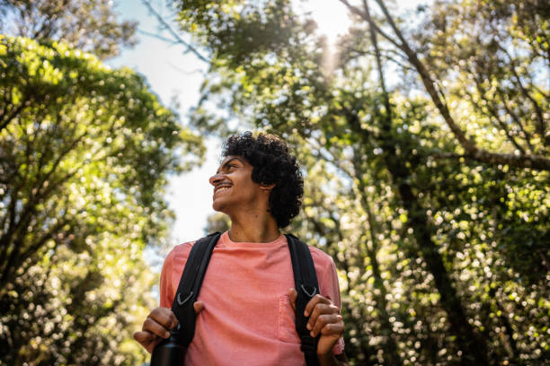 istock Young man walking and looking around hiking on forest 2099741194