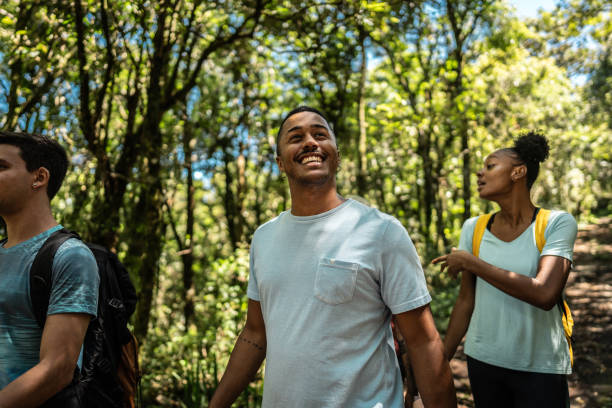 istock Young man walking and looking around hiking on forest 2099742244