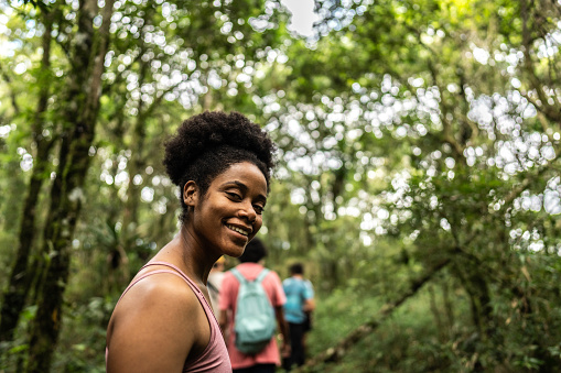 Portrait of a young woman hiking on forest