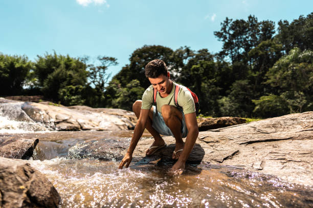 istock Young man looking the river on a mountain during eco tourism 2099747148