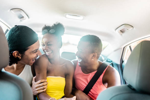 istock Young friends having fun inside of car on a road trip 2099763758