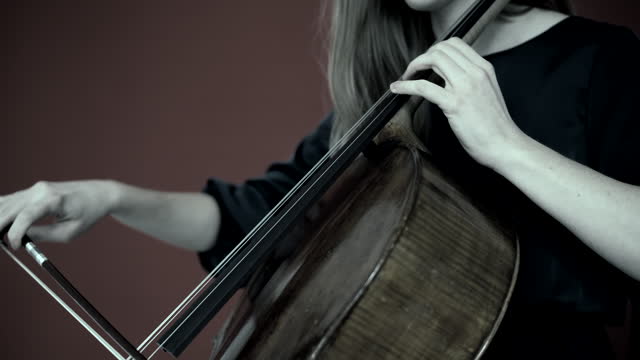 cinematic, young woman playing the cello