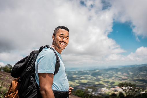 Portrait of a young man doing a trail on a mountain
