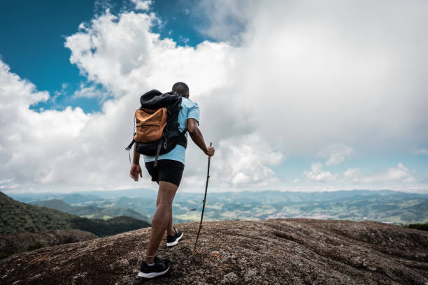 istock Rear view of a young man doing a trail on a mountain 2099770883
