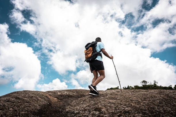 istock Rear view of a young man doing a trail on a mountain 2099771416