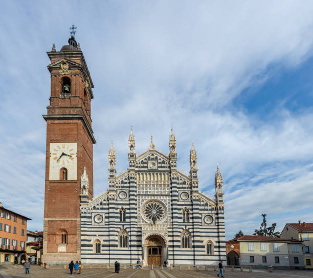Monza, Italy - February 24, 2022: View of the cathedral (Duomo, Basilica di San Giovanni Battista), with visitors, in Monza, Lombardy, Northern Italy