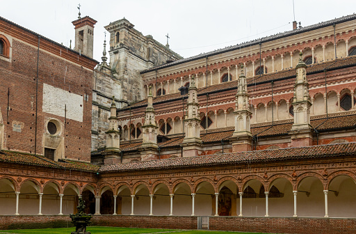 Pavia, Italy - February 27, 2024: Certosa di Pavia, a medieval church and monastery in Pavia, Italy, on a rainy day.