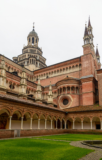 Pavia, Italy - February 27, 2024: Certosa di Pavia, a medieval church and monastery in Pavia, Italy, on a rainy day.