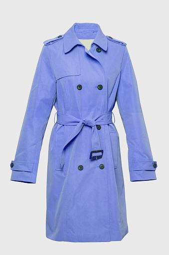 Woman trench coat. A luxurious and stylish elegant female light blue trench coat on mannequin isolated on a white background. Spring and summer fashion.