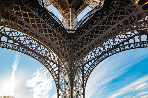 The Eiffel Tower stands tall against the blue sky in Paris.