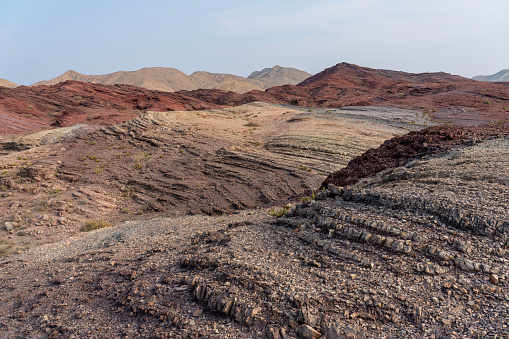 Very colorful sandstone hill in Wahiba desert in Oman.