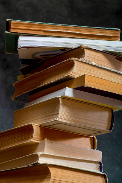 istock A stack of old books and notebooks on the table 2099804361