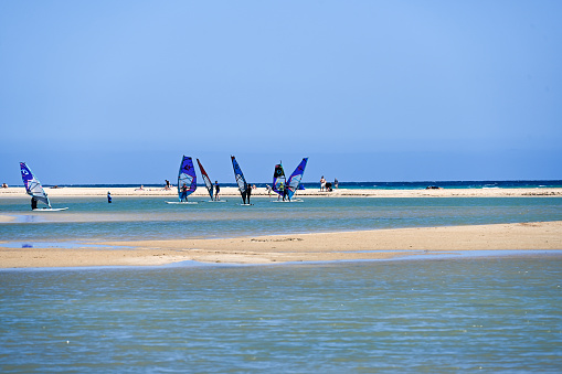 Couple windsurfers in the lagoon of Emerald Sea, Antsiranana bay (Diego Suarez), Madagascar.